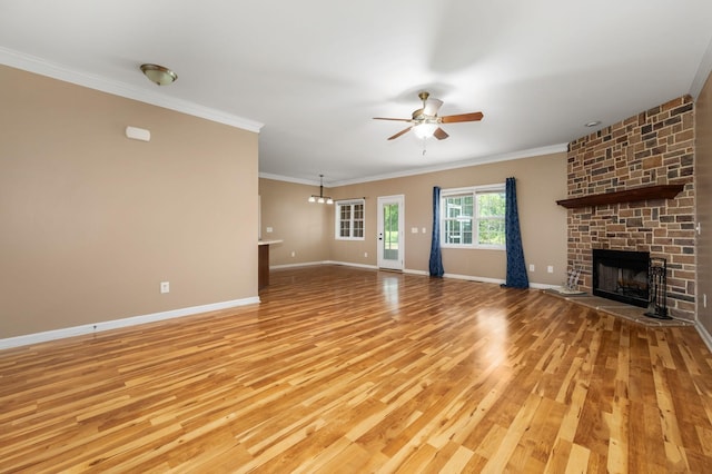 1324 Mockingbird Ln, Murfreesboro, TN 37130 - unfurnished living room with a fireplace, light wood finished floors, a ceiling fan, ornamental molding, and a chandelier