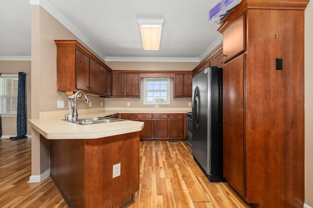 1324 Mockingbird Ln, Murfreesboro, TN 37130 - kitchen featuring freestanding refrigerator, a peninsula, light wood-style flooring, light countertops, and crown molding