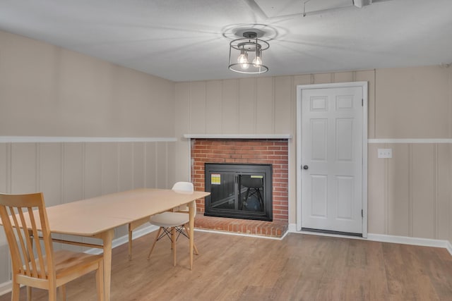 909 Woods Lake Dr, Madison, TN 37115 - dining area featuring a decorative wall, wood finished floors, a fireplace, and wainscoting