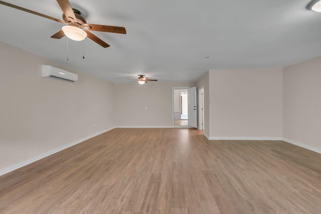 909 Woods Lake Dr, Madison, TN 37115 - unfurnished room with a wall mounted AC, ceiling fan, and light wood-style flooring