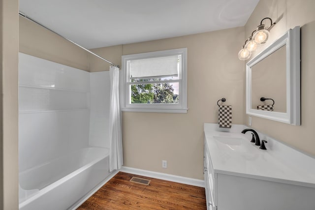 909 Woods Lake Dr, Madison, TN 37115 - bathroom with vanity, wood finished floors, and shower / tub combo