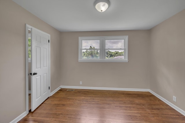 909 Woods Lake Dr, Madison, TN 37115 - unfurnished bedroom featuring multiple windows and dark wood-style floors