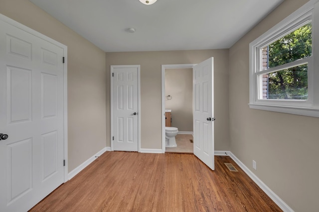 909 Woods Lake Dr, Madison, TN 37115 - unfurnished bedroom featuring wood finished floors and ensuite bath