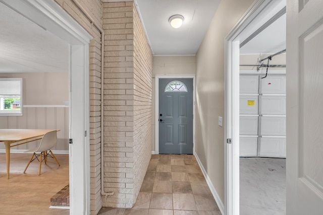 909 Woods Lake Dr, Madison, TN 37115 - foyer entrance with brick wall and baseboards