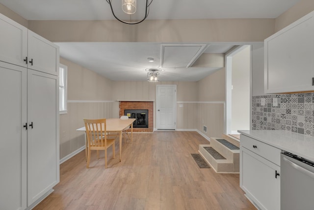 909 Woods Lake Dr, Madison, TN 37115 - unfurnished dining area with a fireplace, light wood-type flooring, and wainscoting