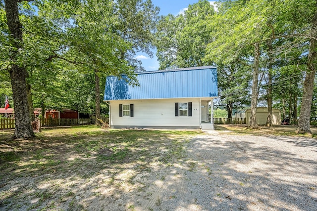 55 Parker Pt, Beechgrove, TN 37018 - rear view of house with a metal roof, a storage shed, and driveway