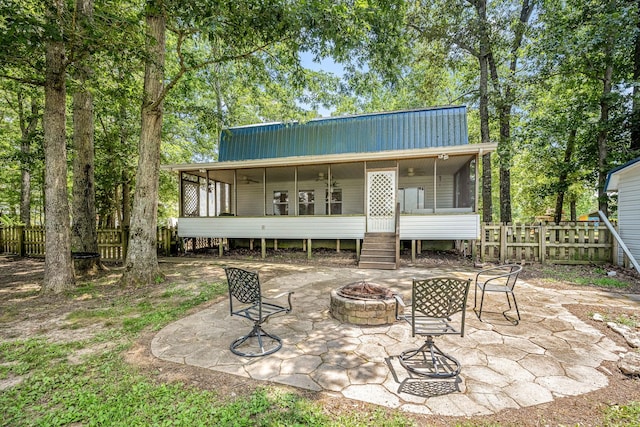 55 Parker Pt, Beechgrove, TN 37018 - back of property featuring a sunroom, an outdoor fire pit, a patio, and a metal roof