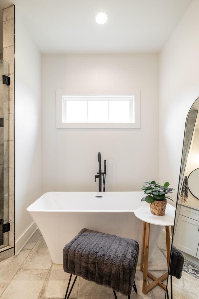 1446 Littleton Ranch Rd, Castalian Springs, TN 37031 - full bath with a soaking tub, plenty of natural light, a stall shower, and recessed lighting