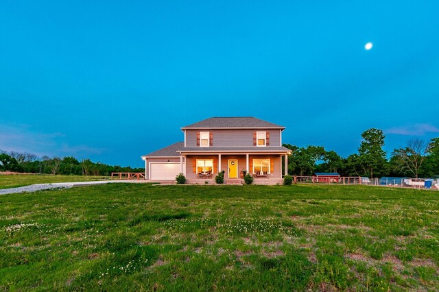1446 Littleton Ranch Rd, Castalian Springs, TN 37031 - view of front of home featuring an attached garage, covered porch, driveway, and a front lawn