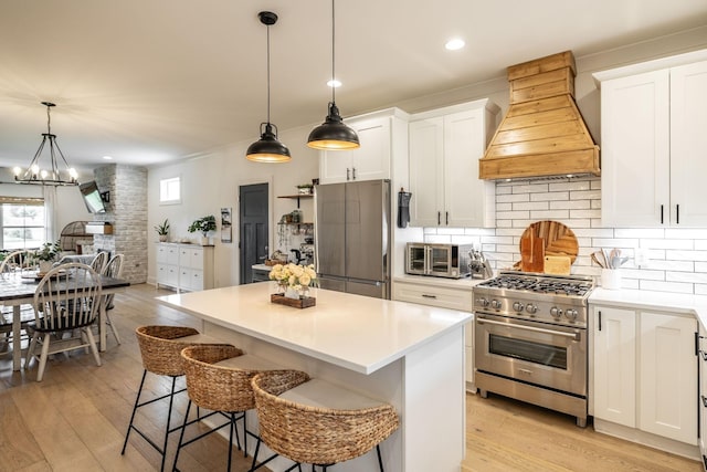 1446 Littleton Ranch Rd, Castalian Springs, TN 37031 - kitchen featuring custom exhaust hood, appliances with stainless steel finishes, healthy amount of natural light, decorative backsplash, and recessed lighting