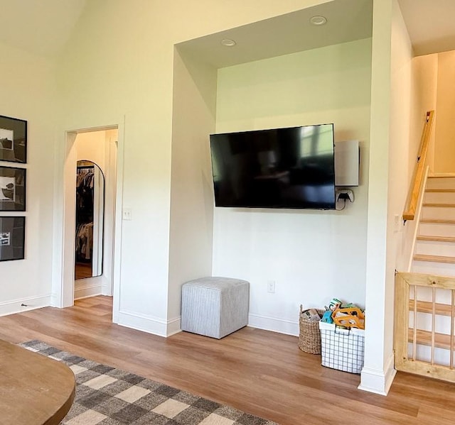 1782 Honey Ln, Estill Springs, TN 37330 - living area featuring wood finished floors, arched walkways, stairway, and recessed lighting