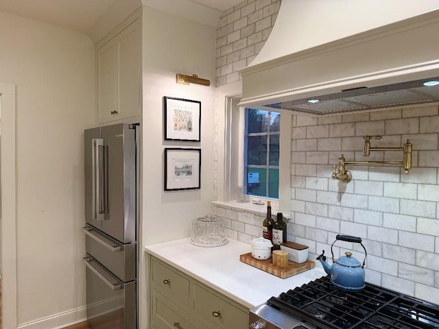 1782 Honey Ln, Estill Springs, TN 37330 - kitchen with high end fridge, premium range hood, decorative backsplash, light countertops, and range