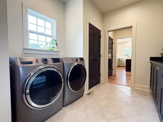 1782 Honey Ln, Estill Springs, TN 37330 - laundry room featuring washing machine and dryer, light tile patterned floors, and plenty of natural light