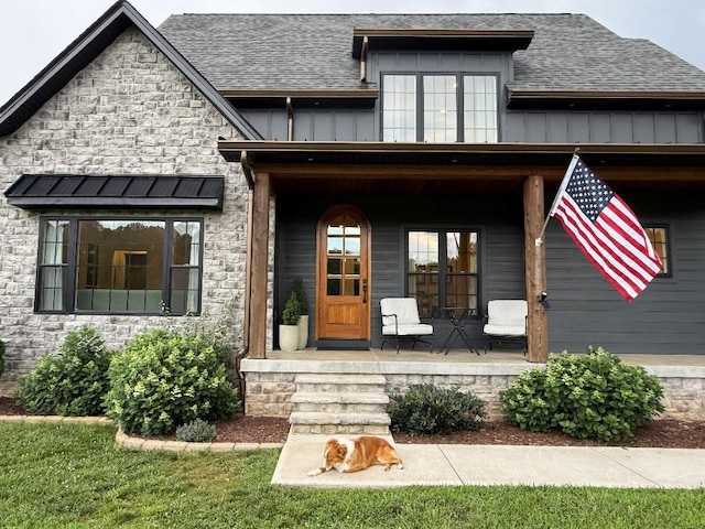 1782 Honey Ln, Estill Springs, TN 37330 - entrance to property with covered porch, roof with shingles, and stone siding