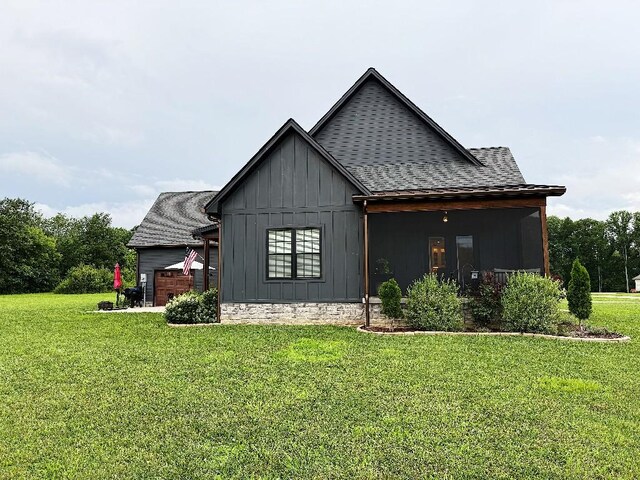 1782 Honey Ln, Estill Springs, TN 37330 - view of property exterior featuring board and batten siding, a yard, an attached garage, and a shingled roof