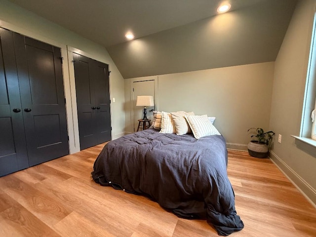 1782 Honey Ln, Estill Springs, TN 37330 - bedroom with lofted ceiling, two closets, and light wood finished floors