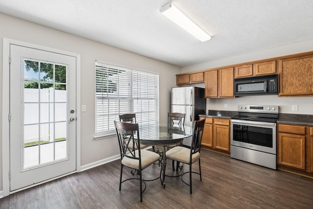 3138 Prater Ct, Murfreesboro, TN 37128 - kitchen with appliances with stainless steel finishes, brown cabinets, dark countertops, and dark wood finished floors
