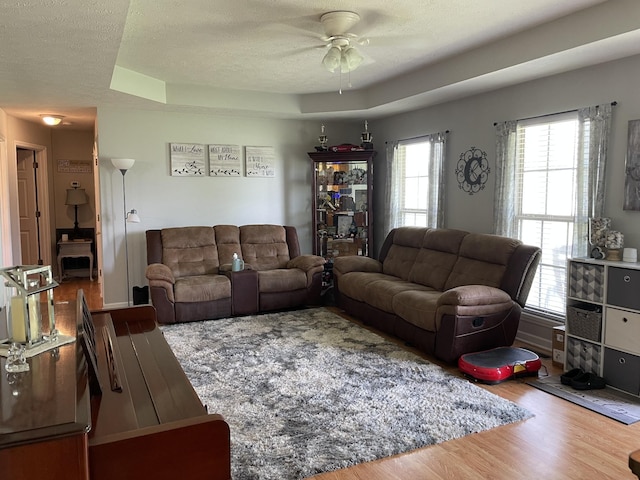 125 Monument Cir, Summertown, TN 38483 - living room with wood finished floors, a ceiling fan, and a textured ceiling