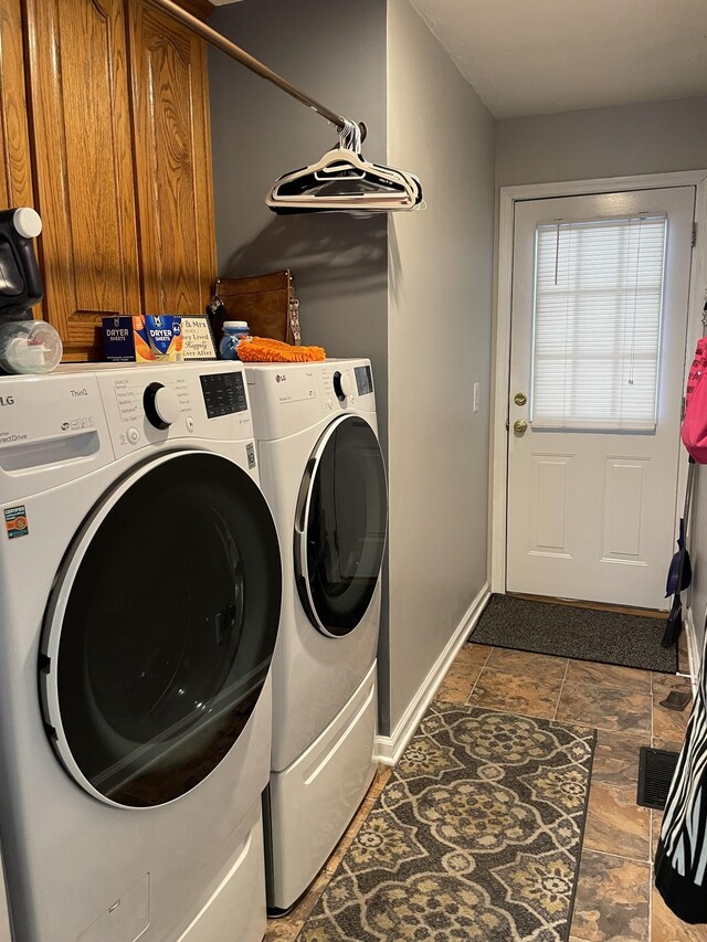 125 Monument Cir, Summertown, TN 38483 - laundry area featuring washer and clothes dryer, dark stone finish flooring, and cabinet space
