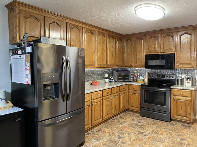 125 Monument Cir, Summertown, TN 38483 - kitchen featuring black microwave, stainless steel refrigerator with ice dispenser, electric stove, brown cabinetry, and a textured ceiling