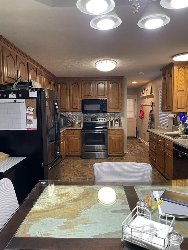 125 Monument Cir, Summertown, TN 38483 - kitchen featuring black appliances, light countertops, brown cabinetry, and decorative backsplash