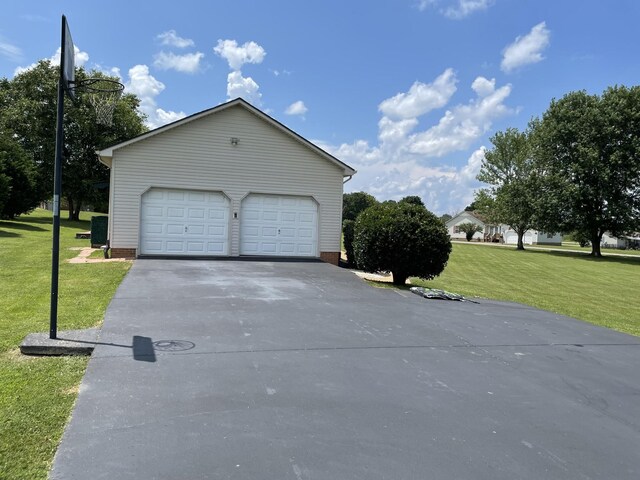 125 Monument Cir, Summertown, TN 38483 - view of front facade with a garage, a front lawn, an outbuilding, and driveway