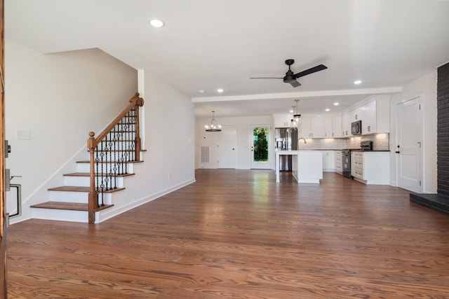 2210 Garners Creek Rd, Dickson, TN 37055 - unfurnished living room featuring dark wood-style floors, a ceiling fan, recessed lighting, stairs, and a chandelier