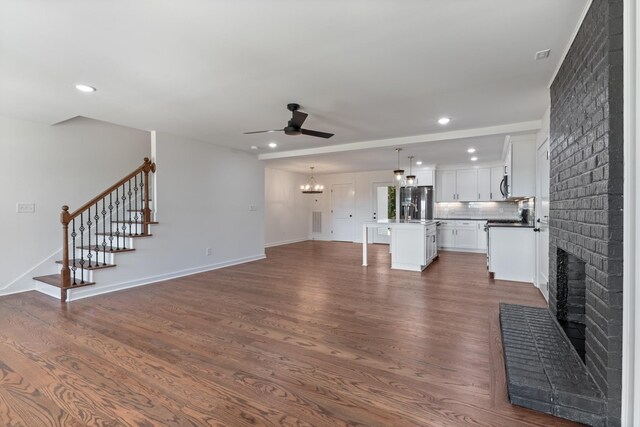 2210 Garners Creek Rd, Dickson, TN 37055 - unfurnished living room featuring a ceiling fan, a fireplace, dark wood finished floors, recessed lighting, and stairway