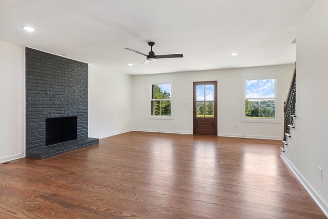 2210 Garners Creek Rd, Dickson, TN 37055 - unfurnished living room featuring ceiling fan, stairs, dark wood-type flooring, a brick fireplace, and recessed lighting