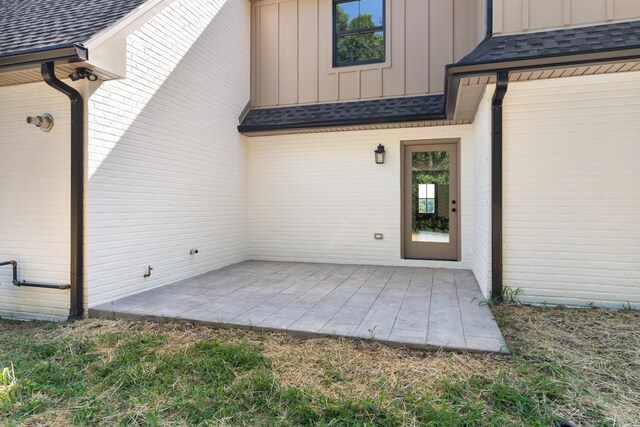 2210 Garners Creek Rd, Dickson, TN 37055 - property entrance featuring board and batten siding, brick siding, and a patio