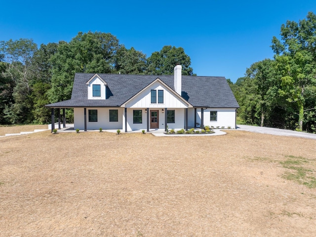 2210 Garners Creek Rd, Dickson, TN 37055 - modern farmhouse featuring covered porch, a chimney, and a shingled roof