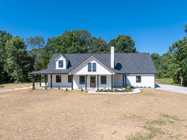 2210 Garners Creek Rd, Dickson, TN 37055 - modern inspired farmhouse featuring a chimney, a porch, and roof with shingles