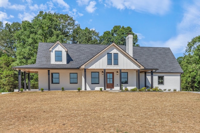2210 Garners Creek Rd, Dickson, TN 37055 - view of front of house featuring roof with shingles, a chimney, covered porch, and brick siding
