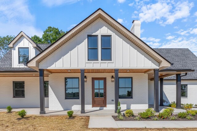 2210 Garners Creek Rd, Dickson, TN 37055 - view of front of home with board and batten siding, covered porch, and brick siding
