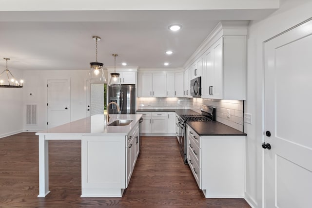 2210 Garners Creek Rd, Dickson, TN 37055 - kitchen with gas range, fridge with ice dispenser, a chandelier, decorative backsplash, and white cabinetry
