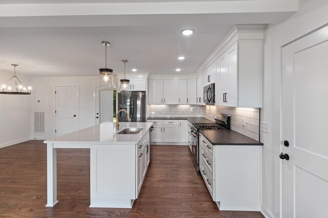 2210 Garners Creek Rd, Dickson, TN 37055 - kitchen with stainless steel appliances, a chandelier, decorative backsplash, white cabinetry, and dark wood-type flooring