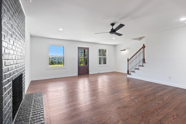 2210 Garners Creek Rd, Dickson, TN 37055 - unfurnished living room with ceiling fan, dark wood-type flooring, stairway, a brick fireplace, and recessed lighting