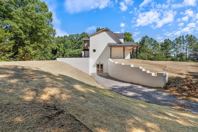 2210 Garners Creek Rd, Dickson, TN 37055 - view of side of home featuring french doors and stucco siding