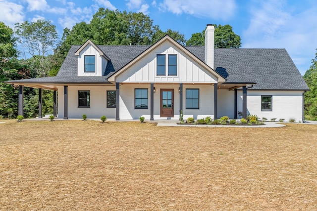 2210 Garners Creek Rd, Dickson, TN 37055 - modern farmhouse style home with a chimney, a shingled roof, brick siding, board and batten siding, and covered porch