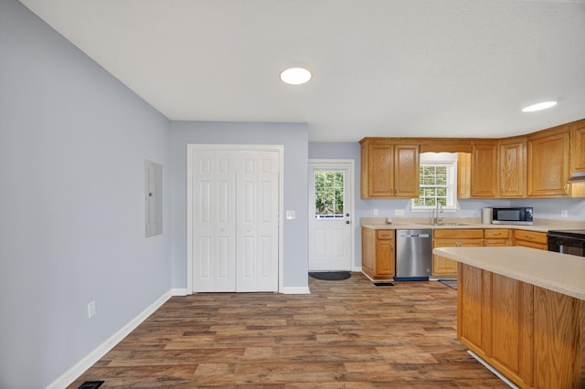7 Summerfield Dr, Fayetteville, TN 37334 - kitchen with appliances with stainless steel finishes, light countertops, wood finished floors, electric panel, and under cabinet range hood