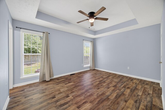 7 Summerfield Dr, Fayetteville, TN 37334 - empty room featuring a tray ceiling, plenty of natural light, wood finished floors, and ceiling fan