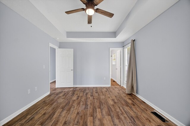 7 Summerfield Dr, Fayetteville, TN 37334 - unfurnished bedroom with a tray ceiling, wood finished floors, and a ceiling fan