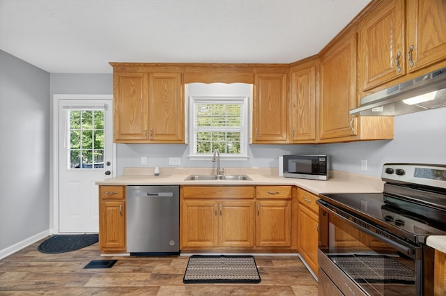 7 Summerfield Dr, Fayetteville, TN 37334 - kitchen featuring stainless steel appliances, under cabinet range hood, light countertops, and light wood-style floors