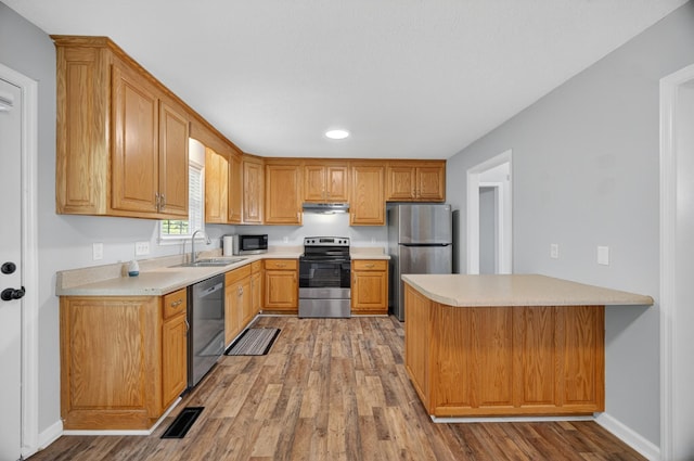 7 Summerfield Dr, Fayetteville, TN 37334 - kitchen with stainless steel appliances, a peninsula, light countertops, light wood-type flooring, and recessed lighting