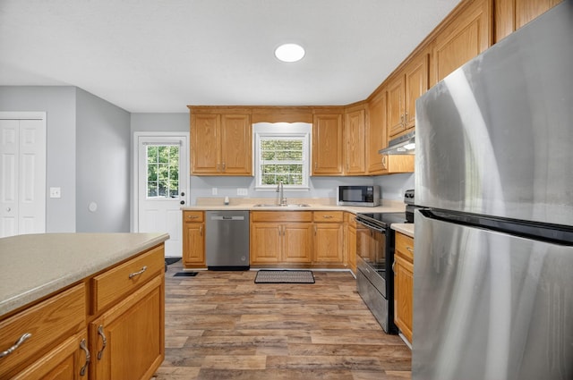 7 Summerfield Dr, Fayetteville, TN 37334 - kitchen featuring appliances with stainless steel finishes, under cabinet range hood, light wood-type flooring, and light countertops