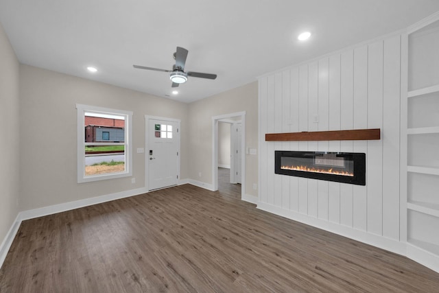1104 Bridge St, Columbia, TN 38401 - unfurnished living room with wood finished floors, a large fireplace, built in features, a ceiling fan, and recessed lighting