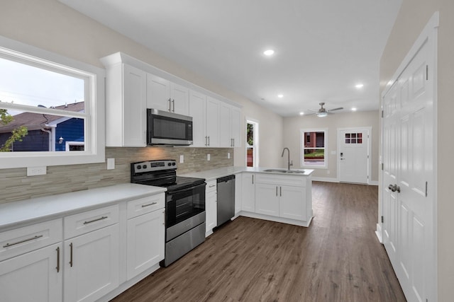 1104 Bridge St, Columbia, TN 38401 - kitchen featuring stainless steel appliances, a peninsula, tasteful backsplash, white cabinetry, and recessed lighting