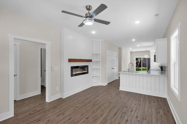 1104 Bridge St, Columbia, TN 38401 - unfurnished living room featuring dark wood-type flooring, a large fireplace, built in features, a ceiling fan, and recessed lighting