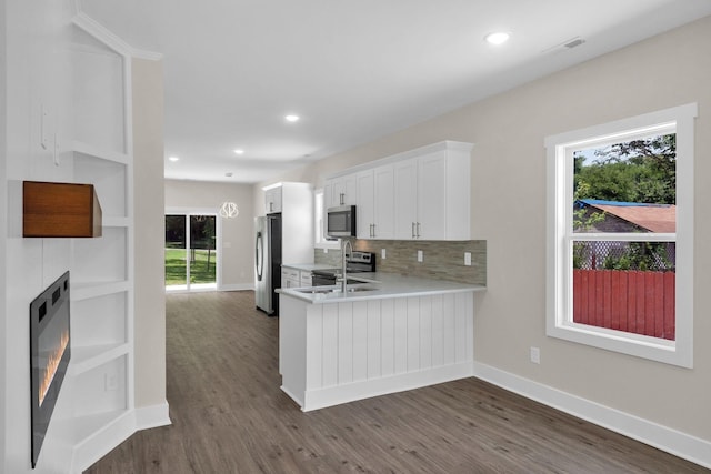1104 Bridge St, Columbia, TN 38401 - kitchen featuring stainless steel appliances, light countertops, dark wood-type flooring, plenty of natural light, and recessed lighting
