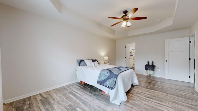 341 Holly Grove Rd, Lewisburg, TN 37091 - bedroom featuring a raised ceiling, light wood-style flooring, ensuite bath, and ceiling fan